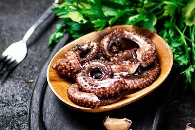 Octopus Pieces on a Cutting Board with Parsley – Free Download