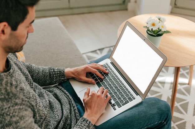 Man Using Laptop on Sofa – Free Stock Photo for Download