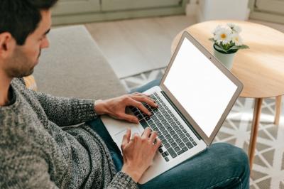 Man Using Laptop on Sofa – Free Stock Photo for Download