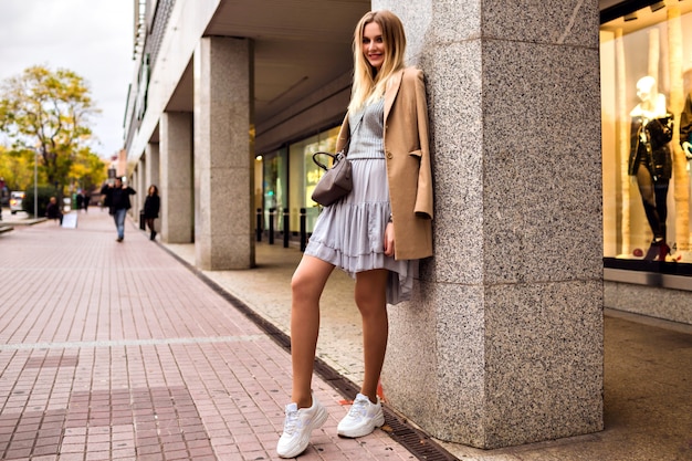 Elegant Outdoor Fashion Portrait of a Blonde Woman in Trendy Sneakers – Free Download