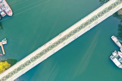 Long Narrow Bridge Over a Large River with Docked Ships – Free Stock Photo for Download