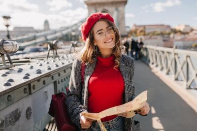 Pleased Brunette Woman with Red Backpack Posing on Urban Bridge – Free to Download