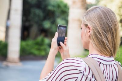 Blonde Young Woman Taking Photograph on Mobile Phone – Free Download