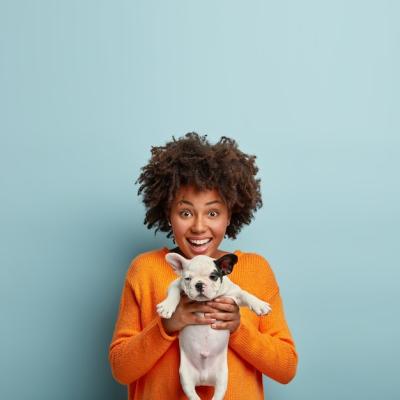 Young Woman with Afro Haircut and Puppy – Free Download