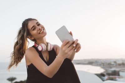 Joyful Young Woman in Sportswear at Seafront During Sunrise – Free Download
