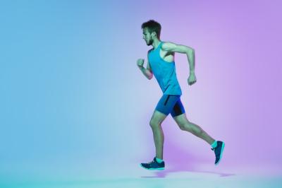 Active Young Caucasian Man Running in Neon Light – Free Download