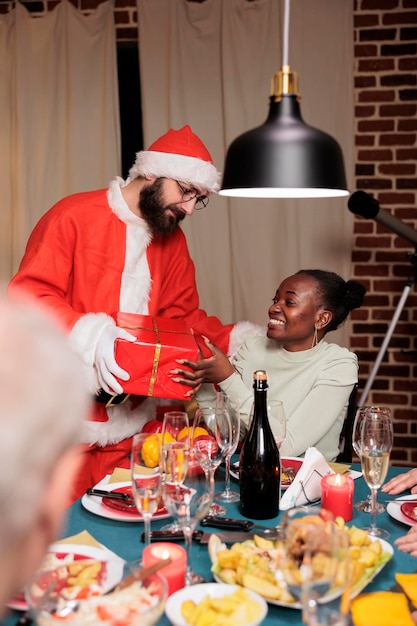 Christmas Celebration: Santa Claus with African American Woman and Friends – Free Download