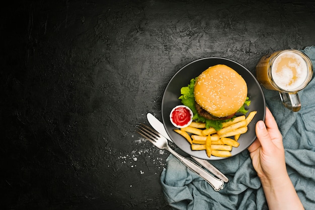 Hand Holding Burger and Fries Flat-lay for Free Download