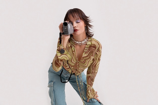 2000’s Fashion Style: Young Woman Holding Camera – Free Download