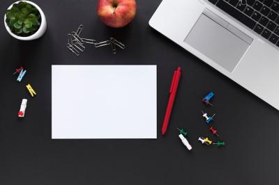 Blank White Card Paper, Pen, Apple, Colorful Office Stationeries, and Laptop on Black Background – Free to Download