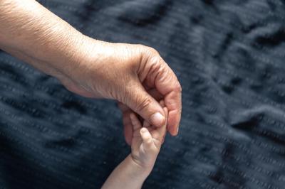 Close-Up of Senior and Baby Hands – Free Download