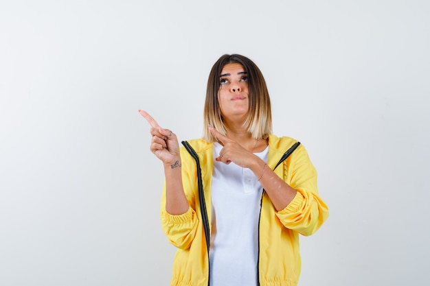 Female Pointing Hesitantly in T-Shirt and Jacket – Free Stock Photo Download