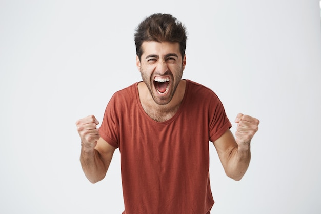 Young Man Celebrating Victory and Success – Free Download