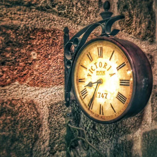 Close-Up of Clock Against Stone Wall – Free Download, Free Stock Photo