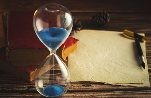 Hourglass and Vintage Books on Wooden Table with Lantern Light – Free Stock Photo, Download Free