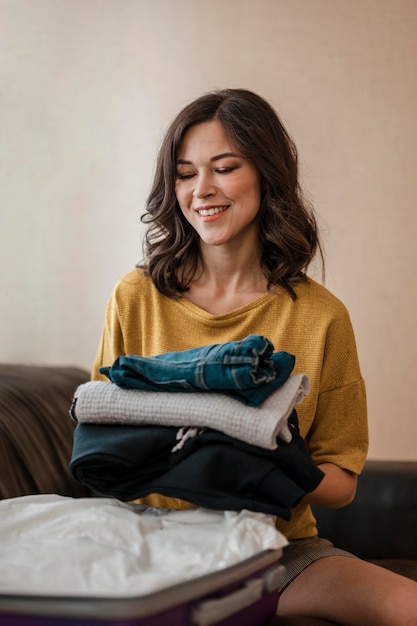 Medium Shot of a Woman Folding Clothes – Free Download