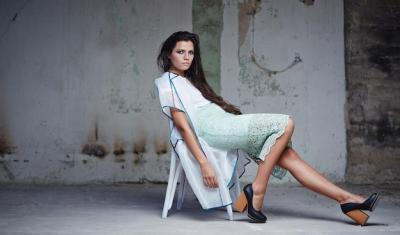 Attractive Woman in White Dress Posing on Chair in Repair Room – Free Stock Photo for Download