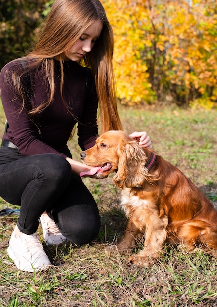 Young Woman Petting Cocker Spaniel – Free Download