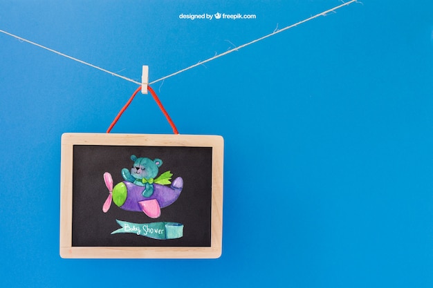 Baby Mockup with Slate Hanging on Clothes Peg – Free Download