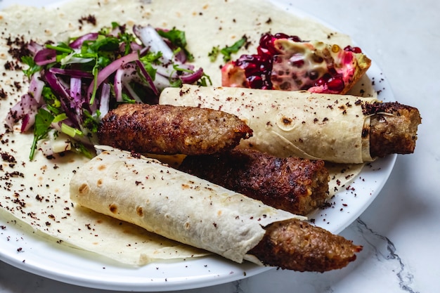 Side View of Lulya Kebab with Pomegranate, Red Onion, and Dried Barberry on Pita – Free Stock Photo for Download