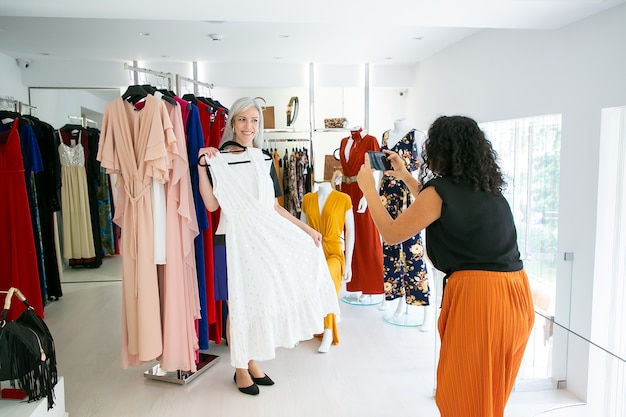 Excited Female Friends Shopping Together in Fashion Store – Free Stock Photo for Download