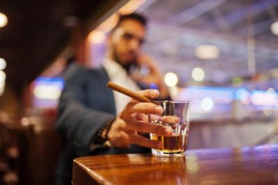 Handsome Arabian Man Enjoying Whiskey and Cigar in Pub – Free Stock Photo for Download