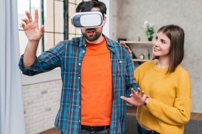 Young Woman Assisting Man in Virtual Reality Experience – Free Stock Photo, Download for Free