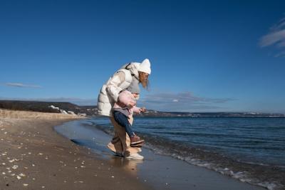 Mother and Child Enjoying a Day at the Beach – Free to Download