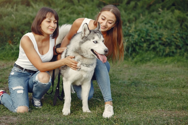 Two Women Enjoying a Spring Day in the Park with a Cute Dog – Free to Download