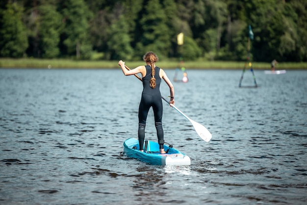 Woman in Black Sports Suit Paddling on Lake – Free Stock Photo for Download