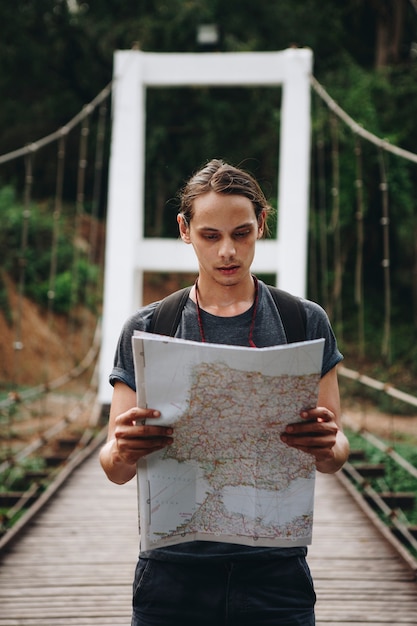 Caucasian Man Looking at a Map: Travel and Explore Concept – Free Download