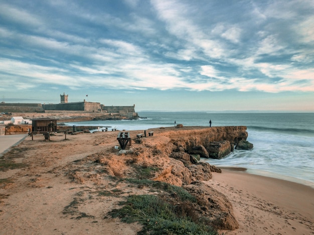 Rocky Dock Overlooking Wavy Sea and Cloudy Sky – Free Download