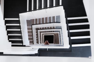 High Angle View of Spiral Staircases and Woman Capturing Photos – Free Download