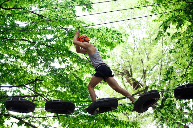 Man Stepping on Hanging Tyres – Free Stock Photo Download