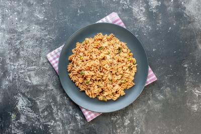 Top View Rotini Pasta on Round Plate with Pink and White Checkered Towel – Free Stock Photo for Download