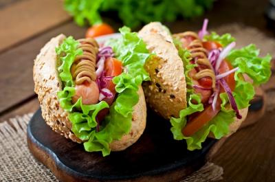 Delicious Hotdog with Ketchup, Mustard, and Lettuce on Wooden Table – Free Stock Photo Download