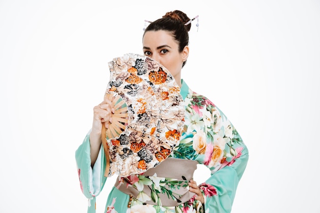 Confident Woman in Traditional Japanese Kimono Holding Hand Fan on White Background – Free Download