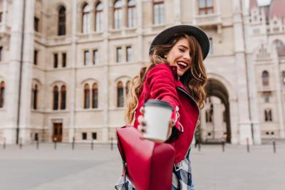 Stylish White Woman Posing with Latte Against an Architectural Wall – Free Download