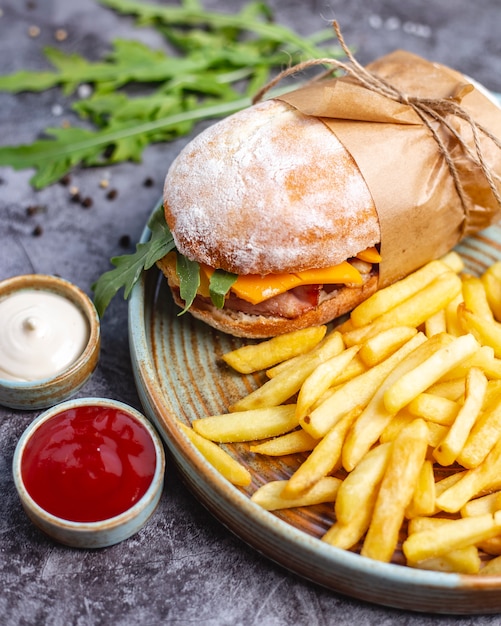 Delicious Chicken Sandwich with Cheddar and Rocket Accompanied by French Fries, Mayonnaise, and Ketchup – Free Download