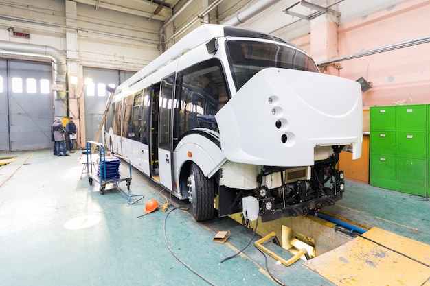 Modern Automatic Bus Manufacturing: Workers in Protective Uniforms – Free to Download