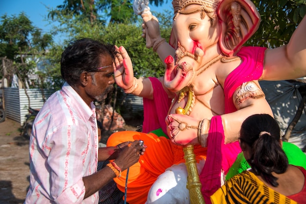 Artist Finishing Touches on Lord Ganesha Idol at Workshop – Free Download