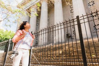 Young Female Tourist with Camera Exploring Urban Architecture – Free Download