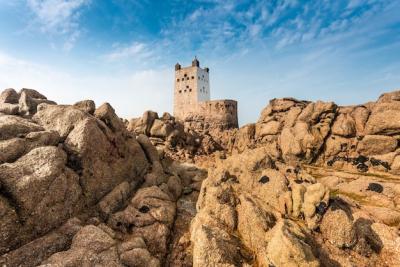 Cliffs and Rocks with a Fort Against a Blue Sky – Free Download