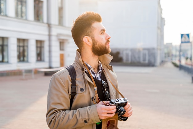 Male Traveler with Vintage Camera Exploring City – Free Download