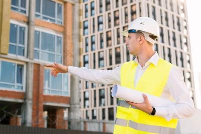 Architect Pointing at Building – Free Stock Photo for Download