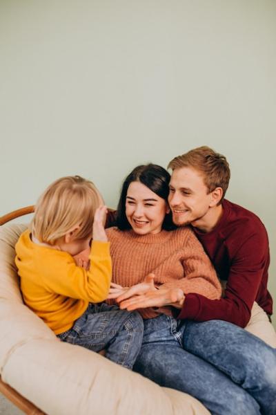 Happy Young Family with Little Son Sitting Together – Download Free Stock Photo