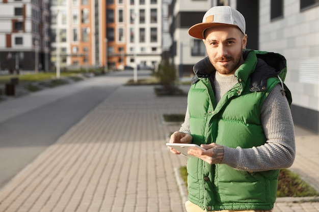 Attractive Unshaven Young Male Messaging Friends Online in City Street – Free Stock Photo, Download for Free