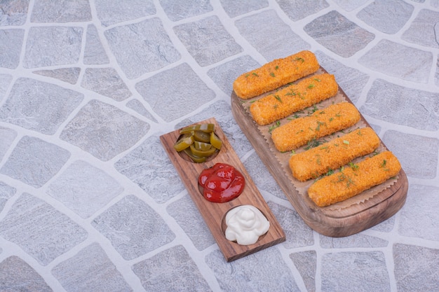 Chicken Nuggets Accompanied by a Variety of Sauces on a Wooden Board – Free Download