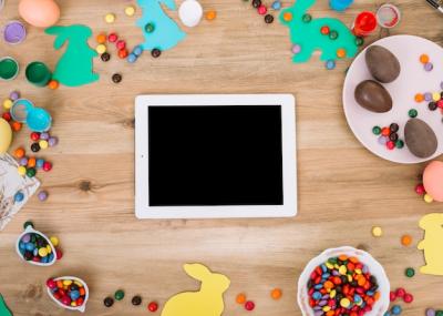 Blank Digital Tablet Surrounded by Colorful Candies and Easter Eggs – Free Download