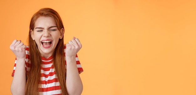 Charming Redhead Celebrating Success with Fist Pump – Free Download